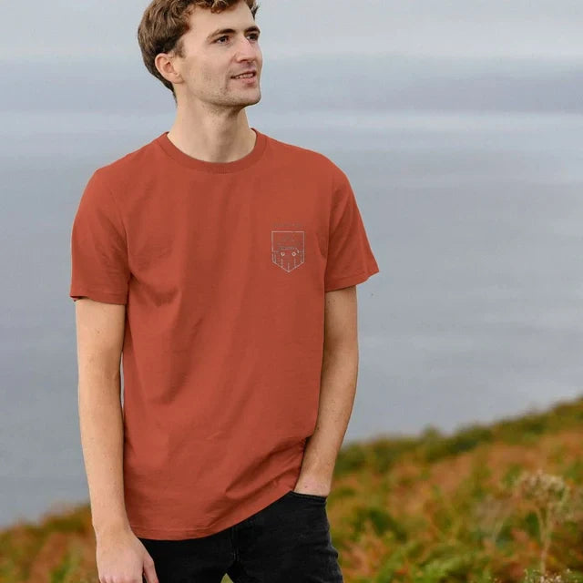 Model wearing Relaxed Fit Organic T-Shirt for Men on a coastal path