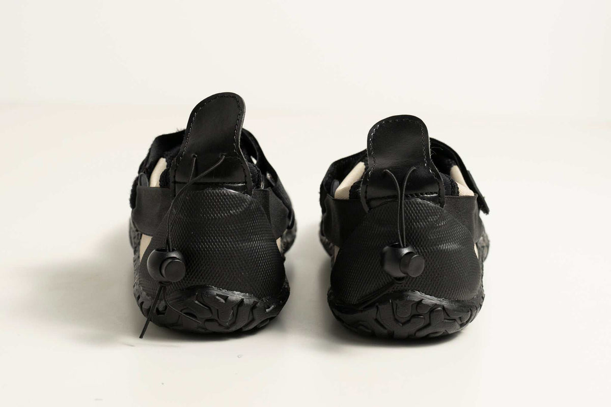 3mm Adult Wetsuit reef boots in black neoprene with textured rubber soles, drawstring cuffs and heel pull tabs.