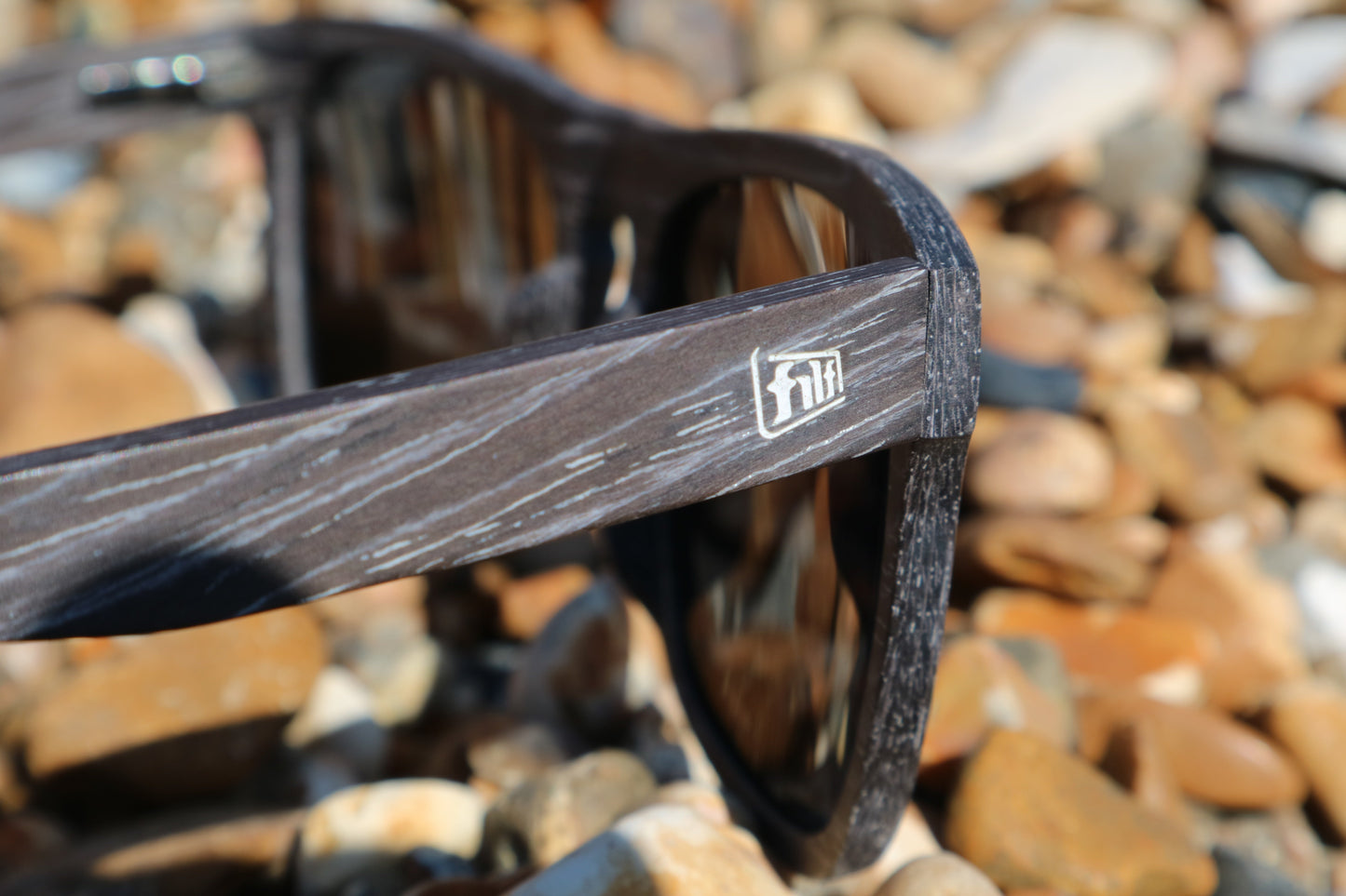 Wave Hog Eco-friendly Sunglasses focus on frame from side angle on logo