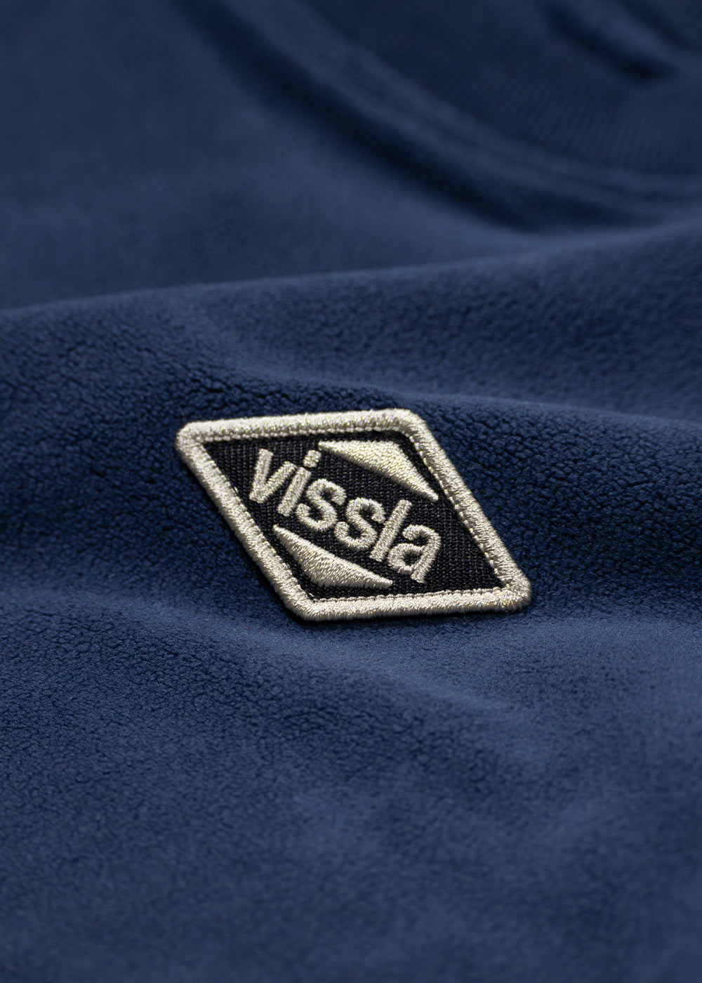 Fleece crewneck with navy blue textured fabric and a cream-edged Vissla chest patch, Vissla Swell Stretch