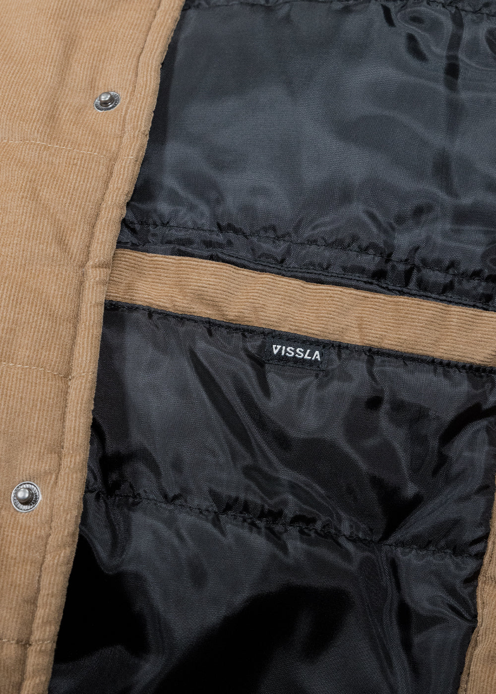 Vissla Paxon Jacket, tan corduroy puffer with black quilted lining and a small Vissla label inside.