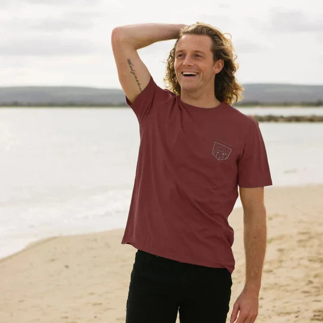 Model wearing Relaxed Fit Organic T-Shirt for Men on a coastal path