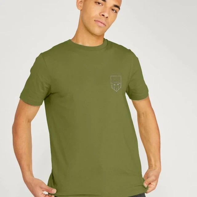 Model wearing Relaxed Fit Organic T-Shirt for Men on a coastal path