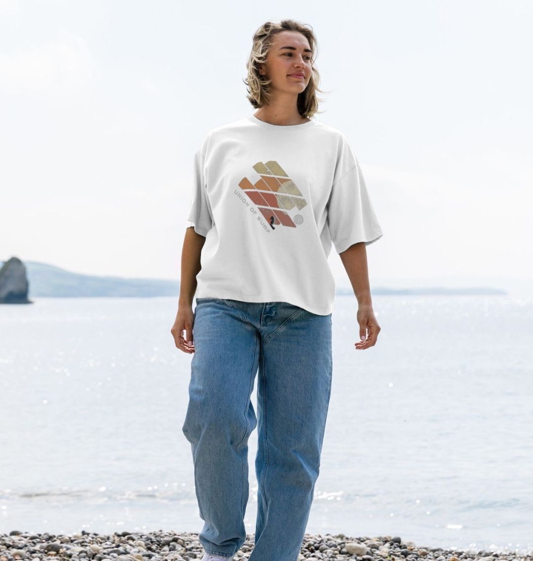a wowmen on the beach wear a coastal print t shirt
