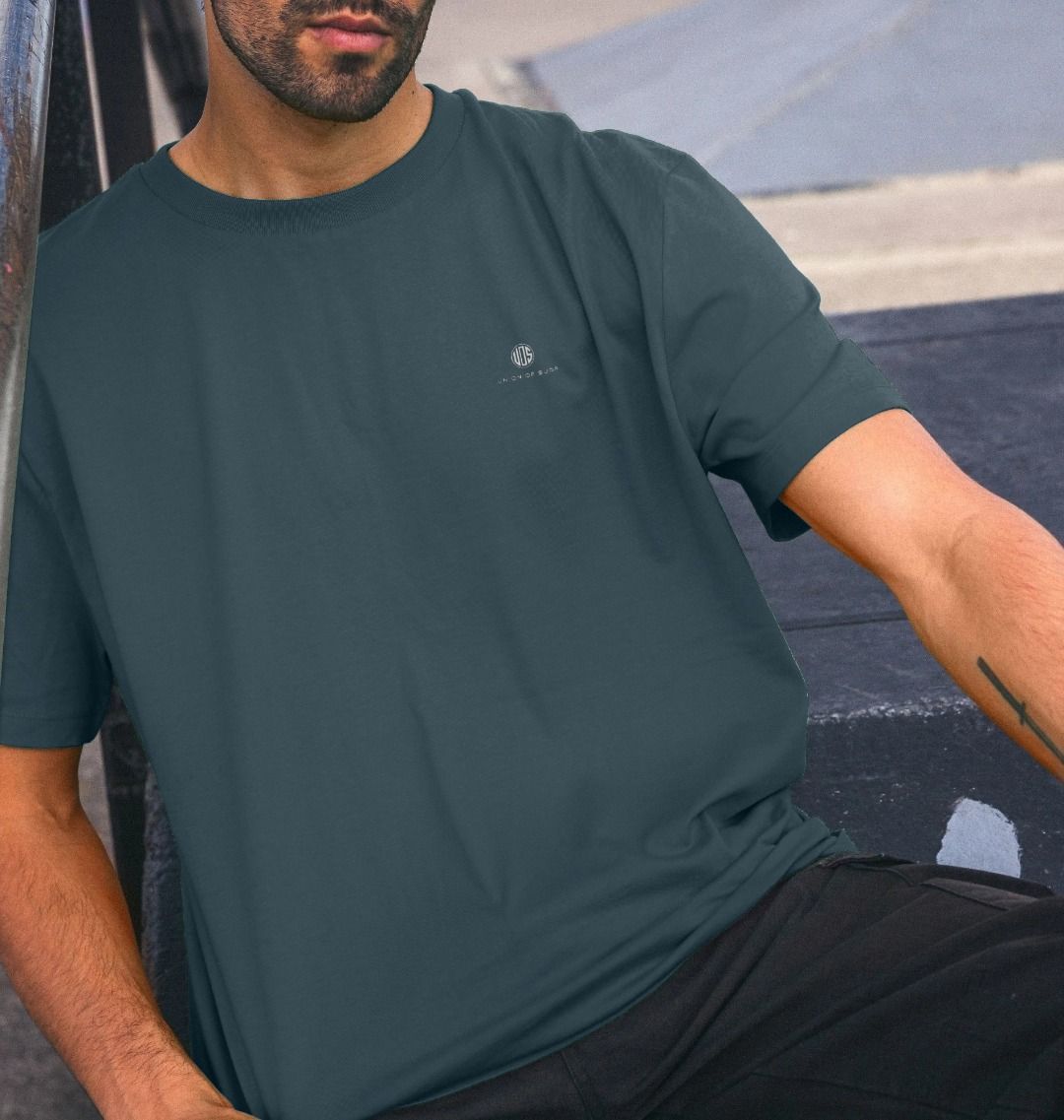 Model wearing Relaxed Fit Organic T-Shirt at a skate park