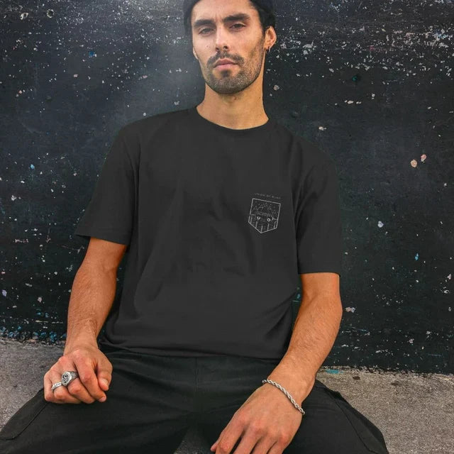 Model wearing Relaxed Fit Organic T-Shirt for Men on a coastal path