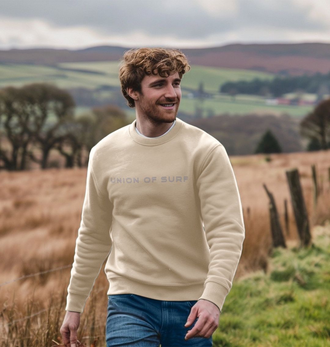 Model wearing Relaxed Fit Coastal Sweatshirt by the ocean, showcasing casual coastal style