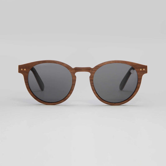 Eye doctor recommending prescribed polarised sunglasses for improved outdoor vision and glare protection