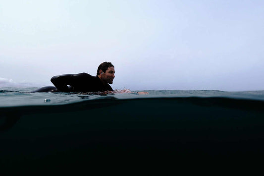 Surfer riding a massive big wave showcasing the thrill and danger of big wave surfing