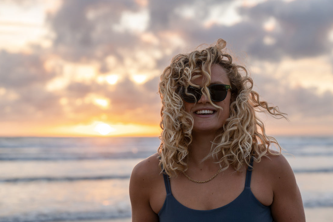 Womens wears polarised sunglasses and the beach