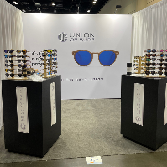 Union of Surf booth showcasing unique wooden surfboards and accessories at Surf Expo Orlando