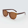 Mini Malibu sunglasses with circular pink camo frame, wooden arms, and rose gold polarized lenses