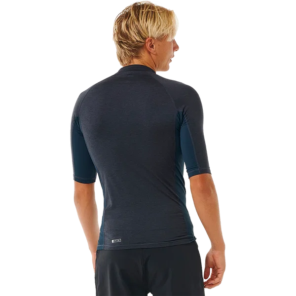 Rip Curl Mens Dawn Patrol short-sleeve rash vest in dark charcoal stretch fabric, with a fitted cut and subtle back hem logo.