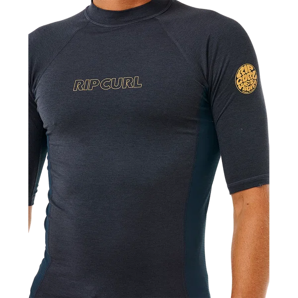 Rip Curl Mens Dawn Patrol short-sleeve rash vest in charcoal marle, with gold chest lettering and sleeve logo.