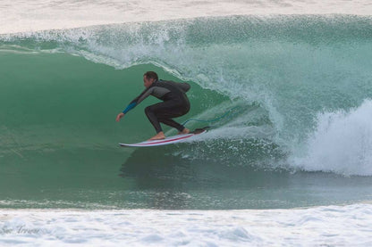 Mens 4/3mm Spring Wetsuit in black neoprene with a full-length back zip, worn surfing in a crouched fit.
