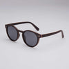 Circular ebony wood sunglasses with black lenses and hand-finished wood grain frame