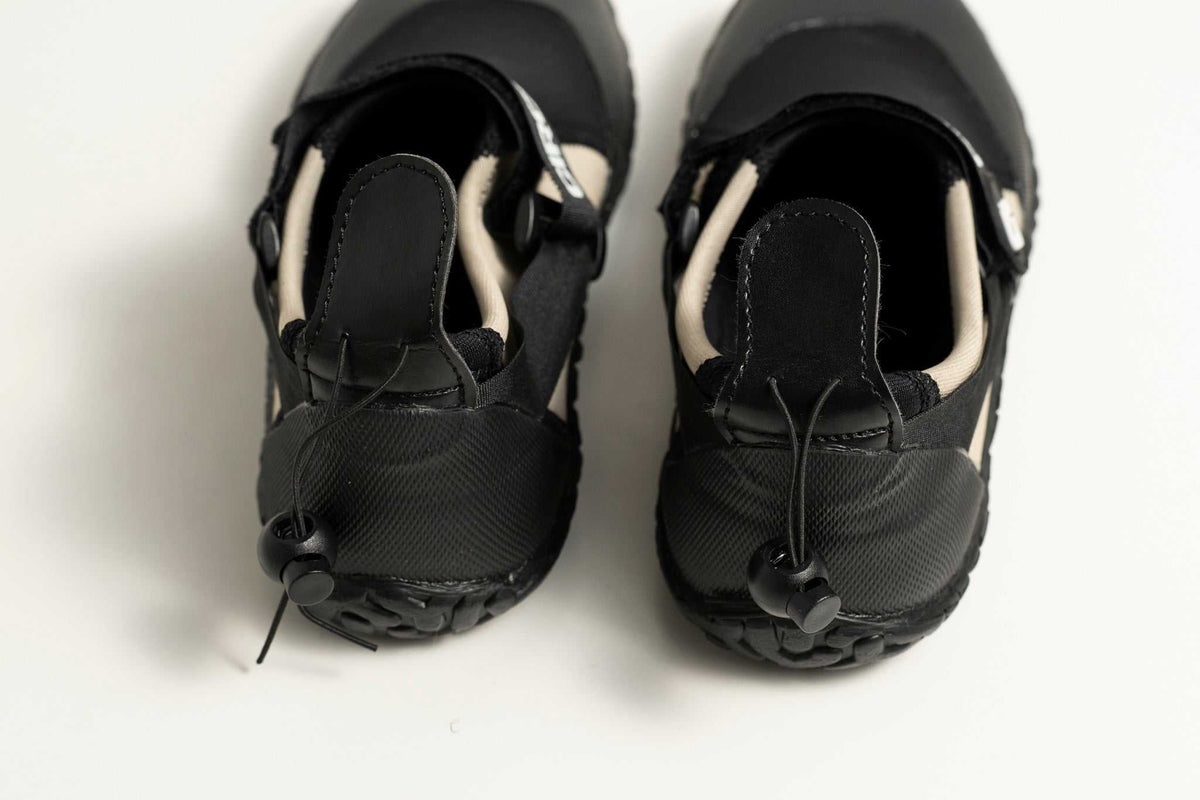 3mm Adult Wetsuit reef boots in black neoprene with textured rubber soles, drawstring cuffs and adjustable ankle straps.