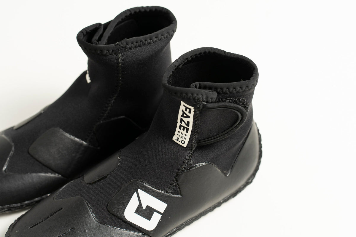 3mm Kids FAZE Wetsuit Boot in black neoprene with a textured rubber sole, ankle-height shaft and adjustable Velcro tab.