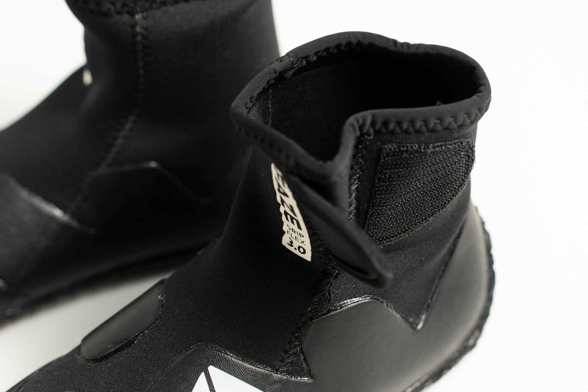 3mm Kids FAZE Wetsuit Boot in black neoprene, with a textured ankle cuff, reinforced panels and a grippy sole.