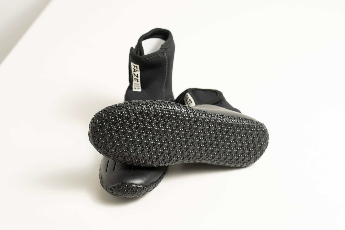 3mm Kids FAZE Wetsuit Boot in black neoprene, with a textured grip sole, ankle support and adjustable hook-and-loop tab.