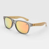 Kuta Beach Colour Party transparent frame sunglasses with grey polarised lenses on the beach