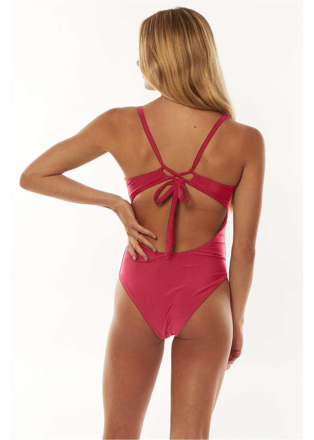 Sisstrevolution Solid Layton one-piece swimsuit in solid magenta, with adjustable crisscross straps and a tie-back cutout.