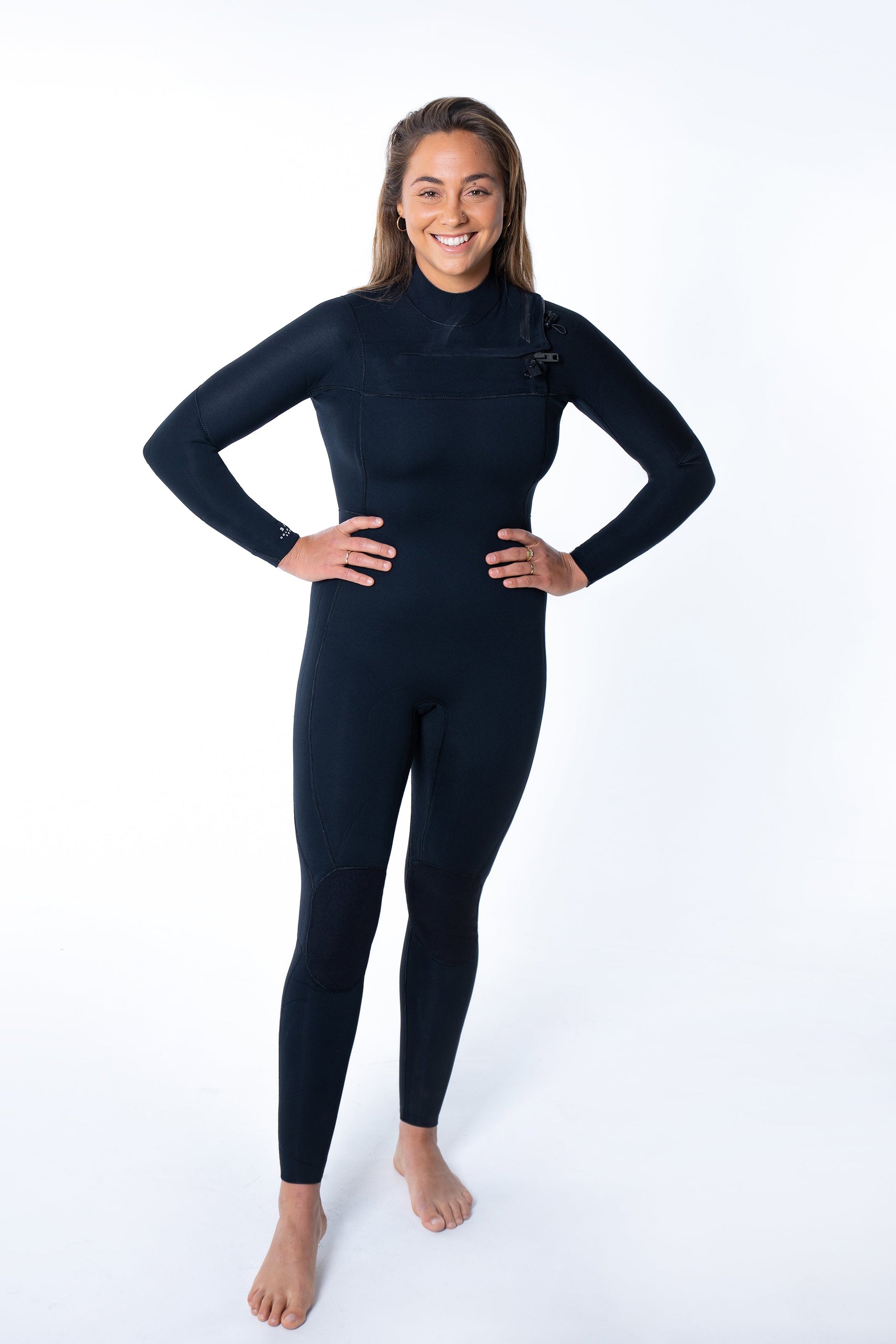 Woman wearing Merino Insulator Series 3/2 chest zip wetsuit with woolly thermal lining for summer surfing