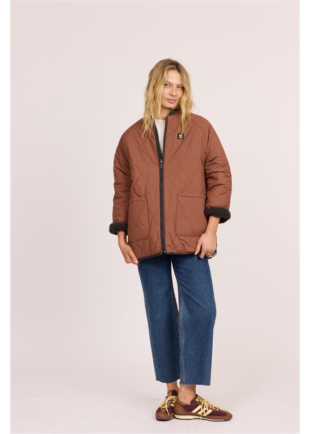 Sisstr Jane Jacket in rust-brown quilted fabric, with black trim, front patch pockets, and a small chest patch.