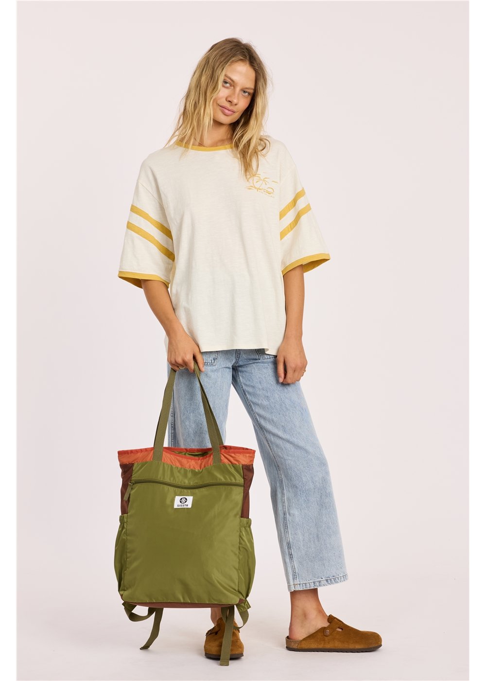 Sisstr Deckhand Tote Backpack in olive green nylon, with rust-colored top trim, carry handles and convertible shoulder straps.