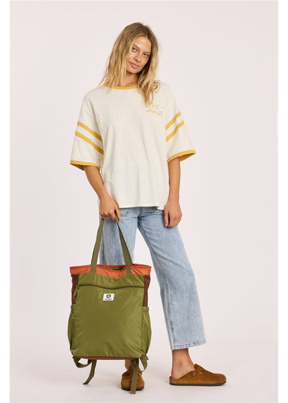 Sisstr Deckhand Tote Backpack in olive green nylon, with rust-colored top trim, carry handles and convertible shoulder straps.