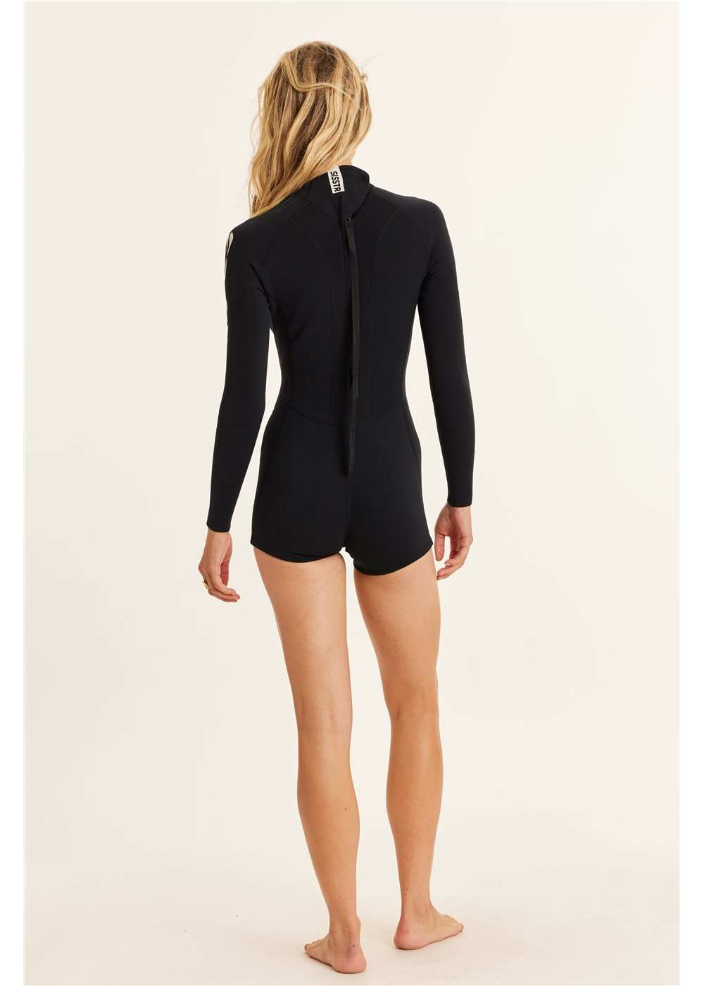 Sisstr 2/2 Summer Seas black long sleeve wetsuit with boy short bottom and back zip closure on model from rear view