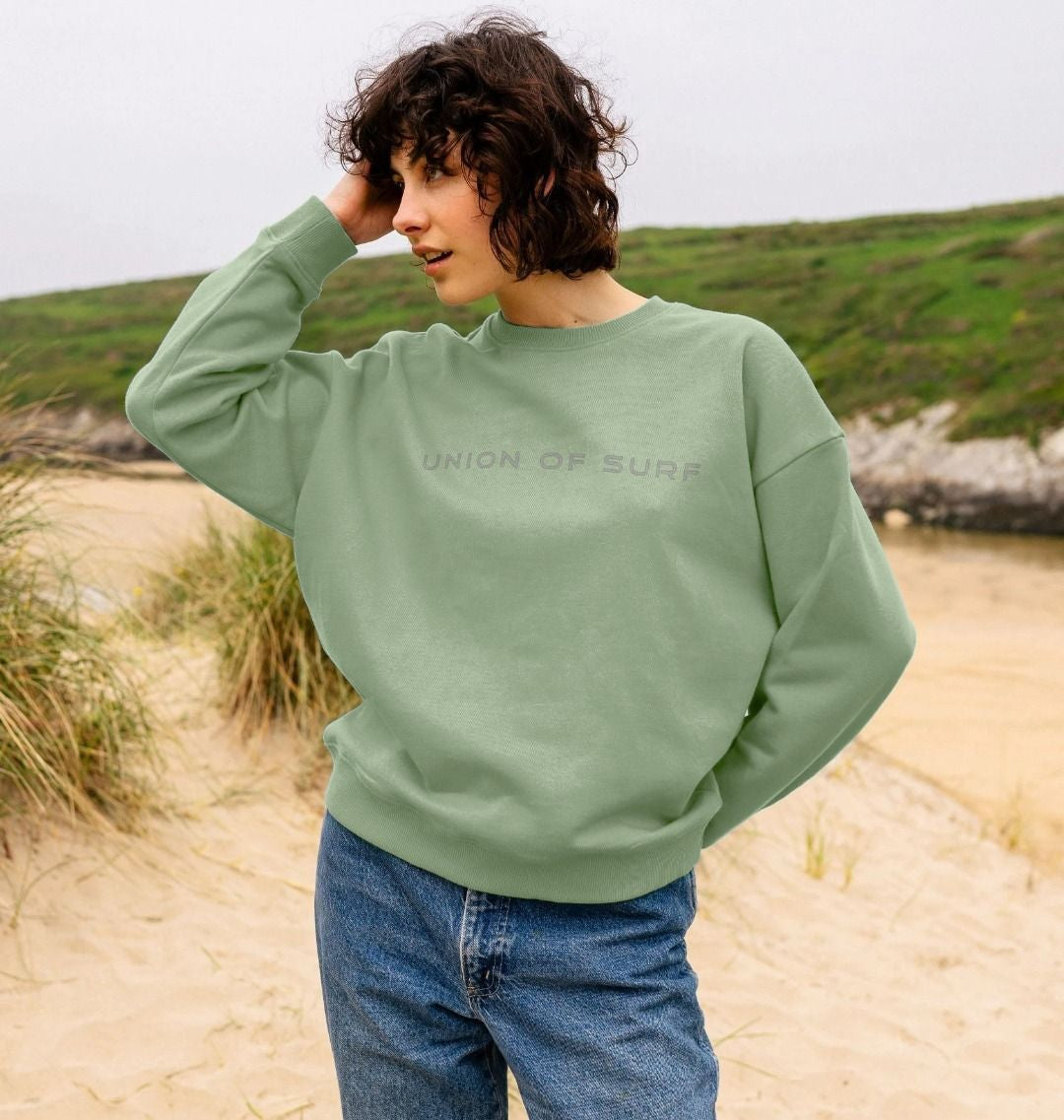 model on the UK beach wears coastal print organic cotton sweater