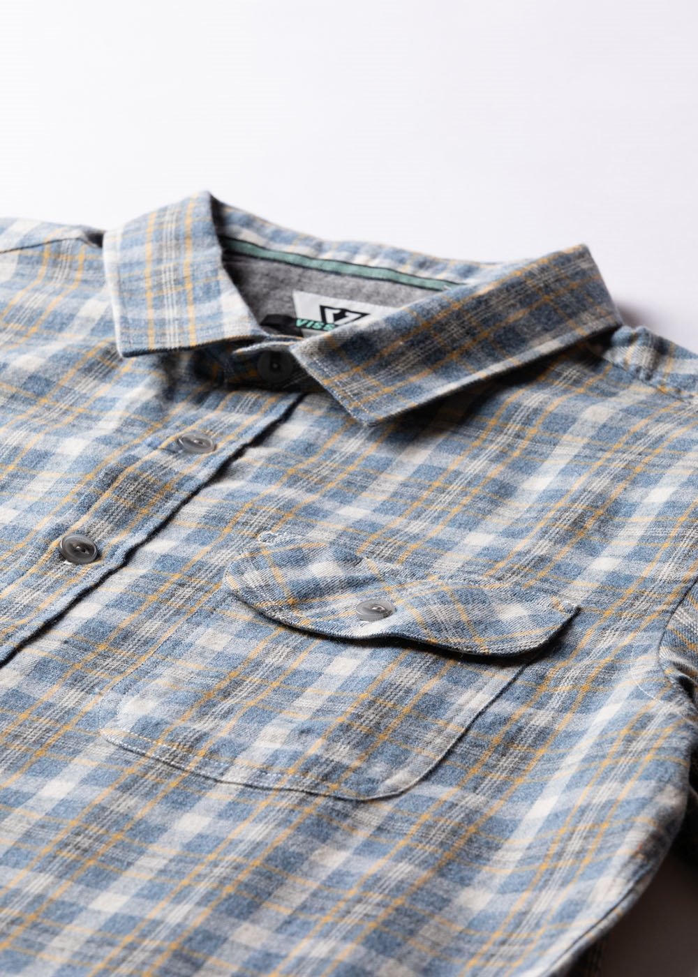 Vissla Central Coast Eco flannel shirt in blue and gray organic cotton plaid, with button front and chest pocket.