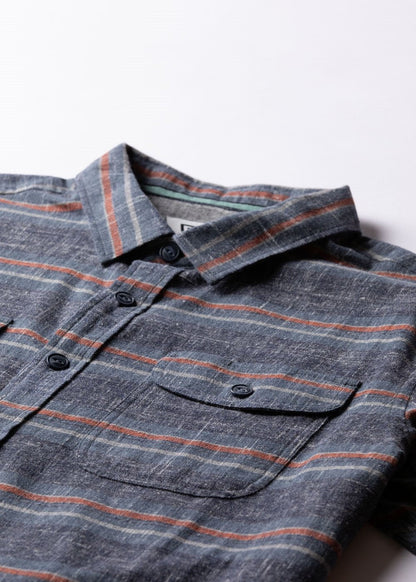 Vissla Central Coast Eco Flannel shirt in charcoal grey plaid, with thin rust stripes, a button front and chest pocket.