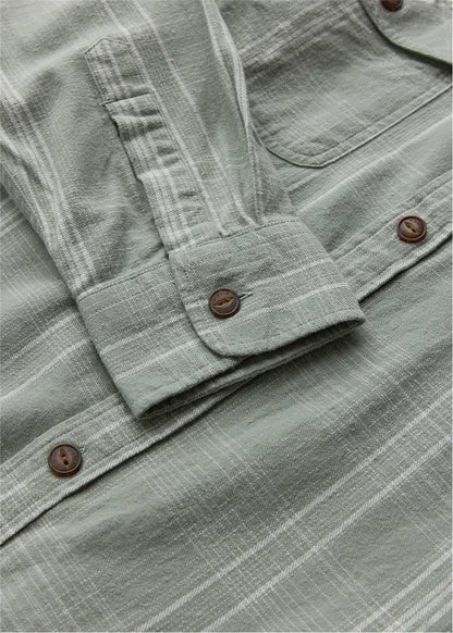Vissla Central Coast Eco cotton flannel shirt in muted sage green plaid, with a button cuff and chest pocket.