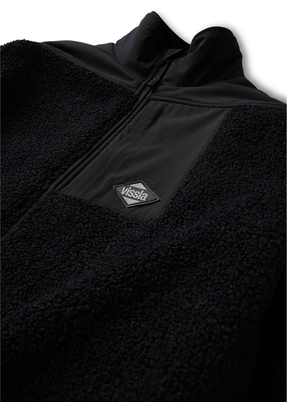 Vissla Kenny Pile Eco Jacket in black textured fleece with smooth contrast panels, a zip front and chest logo patch.
