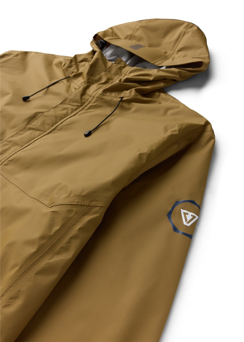 Vissla Noreaster 5K rain jacket in solid tan recycled nylon, with a hood, black drawcords and sleeve logo.