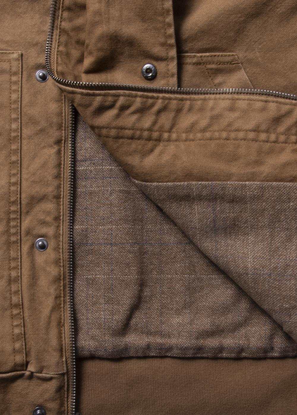 Vissla Creators Grit Jacket in brown cotton canvas, showing a metal zip and soft plaid flannel lining.