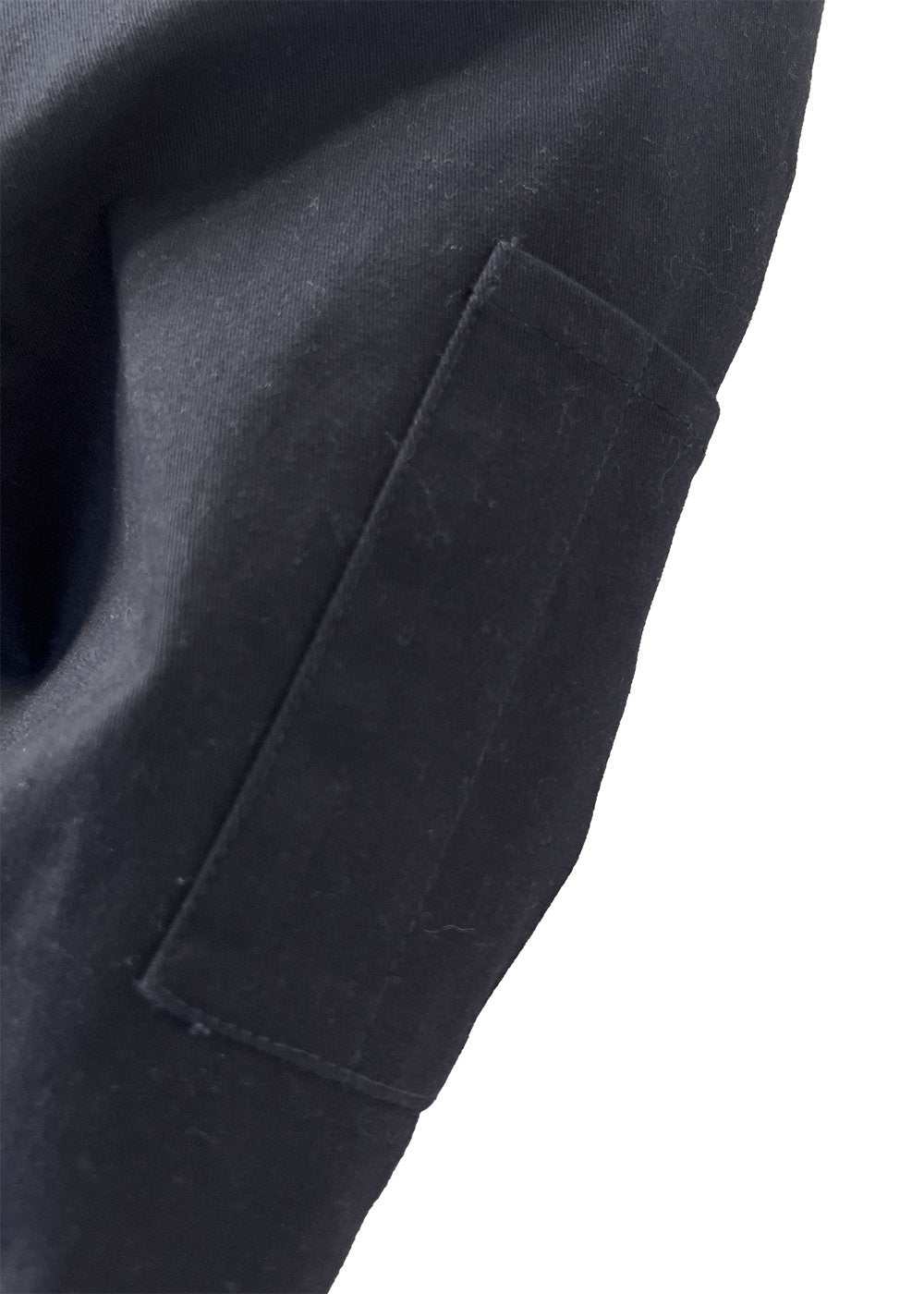 Vissla Creators Eco Port Jacket, dark charcoal cotton-blend twill with a rectangular utility sleeve pocket and stitched edges.
