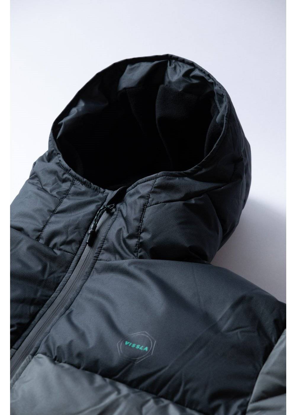 Vissla North Seas II puffer jacket in charcoal grey ripstop fabric, with a hood, front zipper and small chest logo.