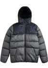 Hooded puffer jacket in dark charcoal recycled polyester with quilted panels, a front zip, and two hand pockets. Vissla North Seas II with elastic cuff binding.