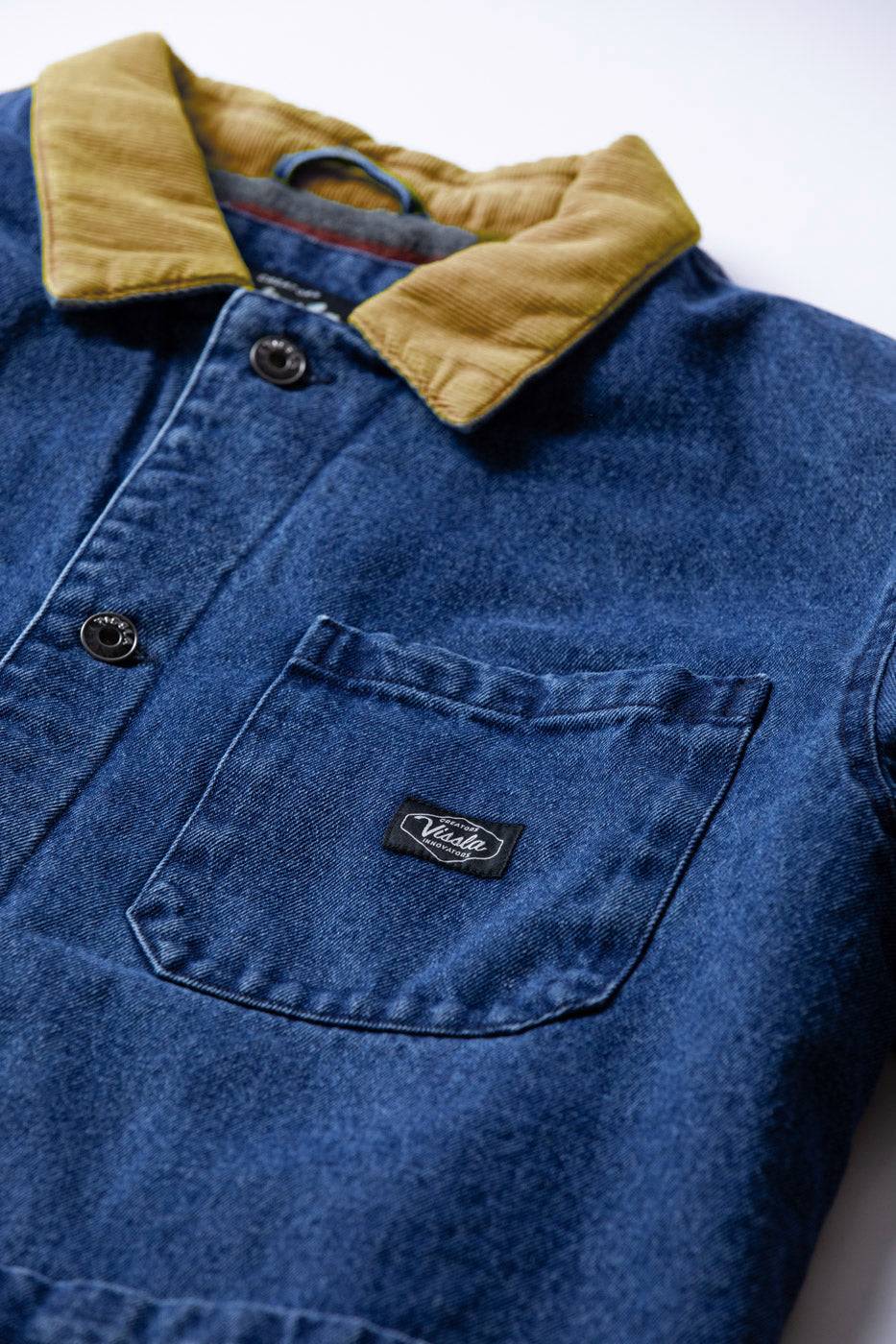 Vissla Peterson Jacket in blue cotton canvas with a tan corduroy collar, dark buttons and a chest pocket.