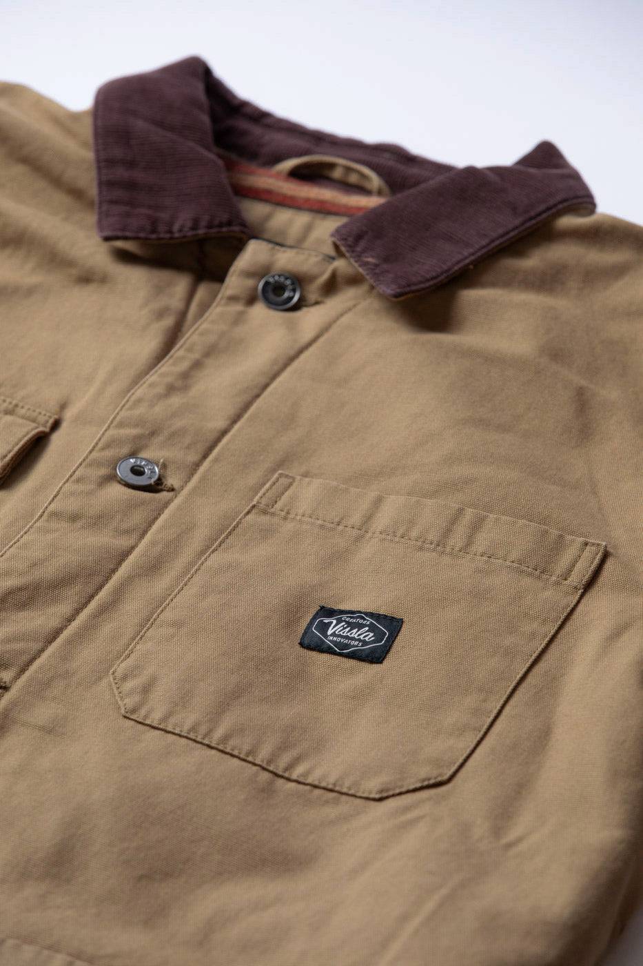 Vissla Peterson Jacket in tan cotton canvas with a dark brown corduroy collar, button front, and large chest pocket.
