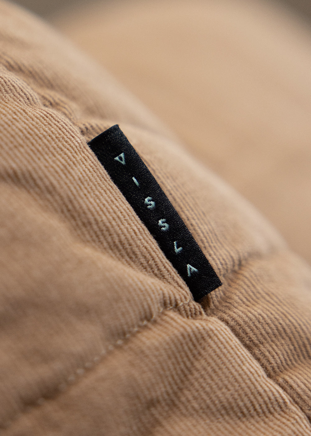 Vissla Paxon Jacket in tan corduroy cotton, featuring fine ridged texture, square quilting and a black woven label.