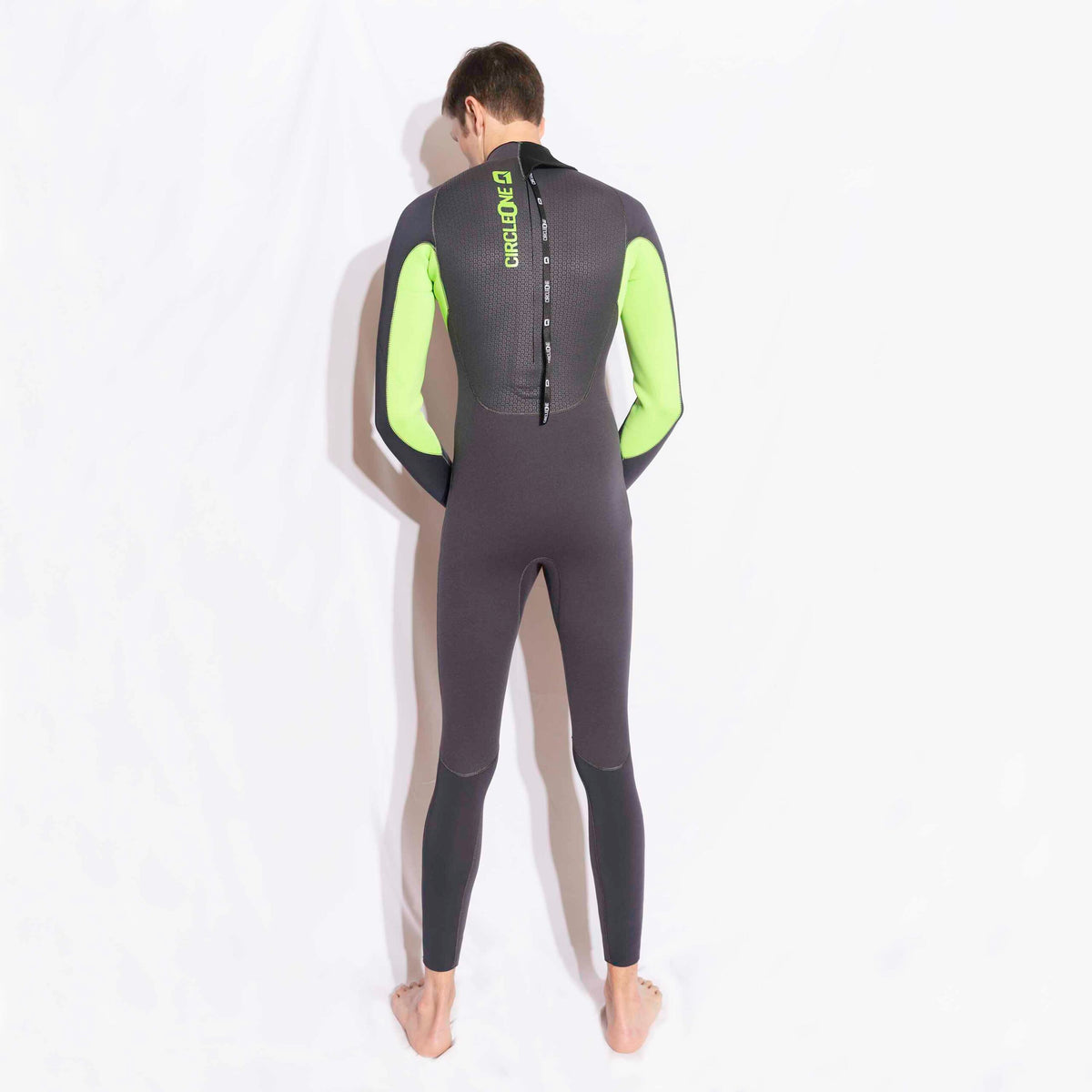 Mens 4/3mm Spring Wetsuit in charcoal neoprene with neon green arm panels, a back zip and knee patches.