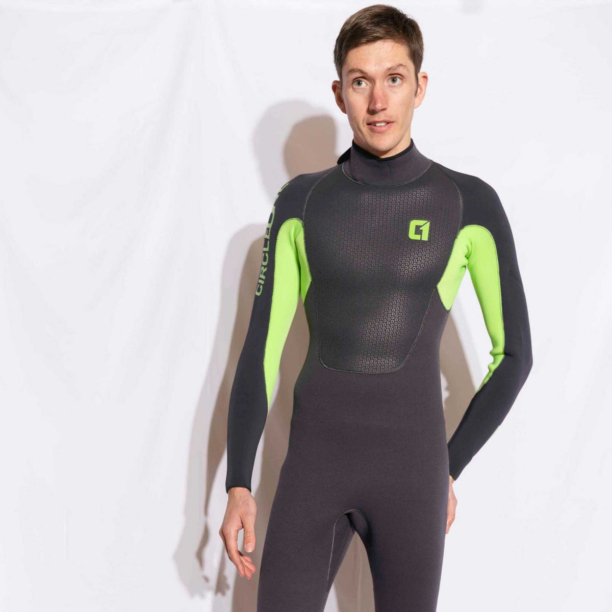 Mens 4/3mm Spring Wetsuit in black neoprene with bright lime-green sleeves and chest logo, featuring a high collar and long sleeves.