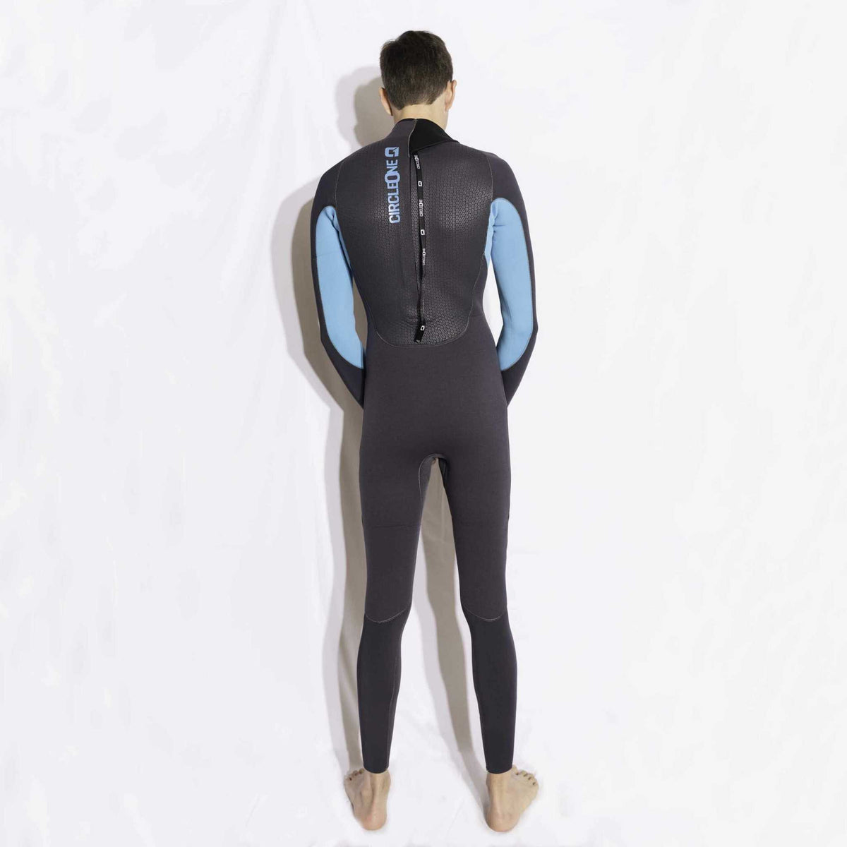 Mens 5/4mm Winter Wetsuit in charcoal neoprene with bright blue arm panels, a back zip and white branding.