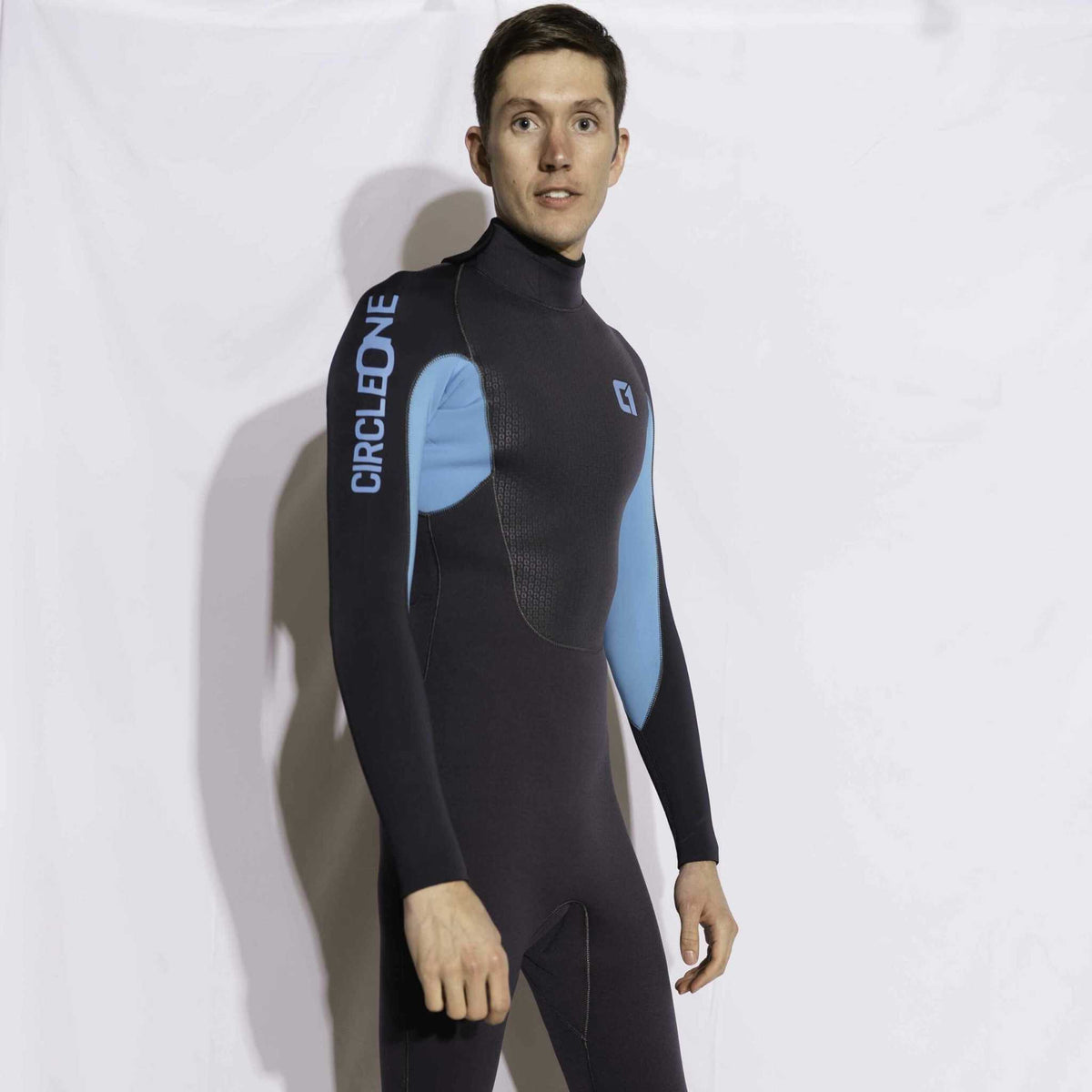 Mens 5/4mm Winter Wetsuit in black neoprene with bright blue panels, high neck, and back zip design.
