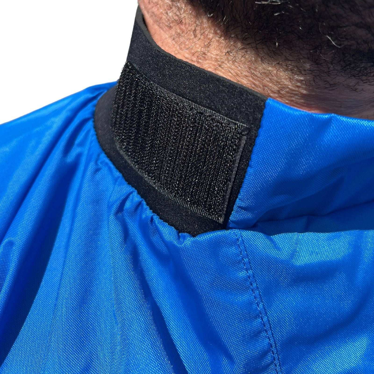 Spray Jacket in bright blue waterproof nylon with a black adjustable Velcro collar and stitched seams.