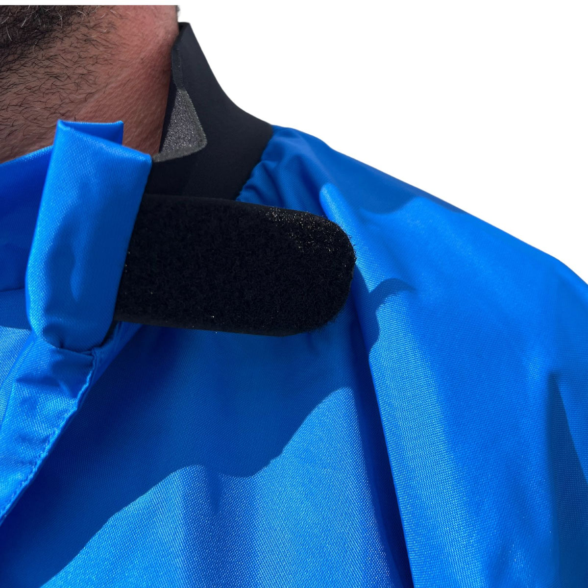 Spray Jacket in bright blue waterproof nylon with a black neoprene collar and wide hook-and-loop closure.